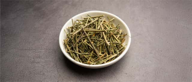 Chirata twigs in white bowl on grey surface